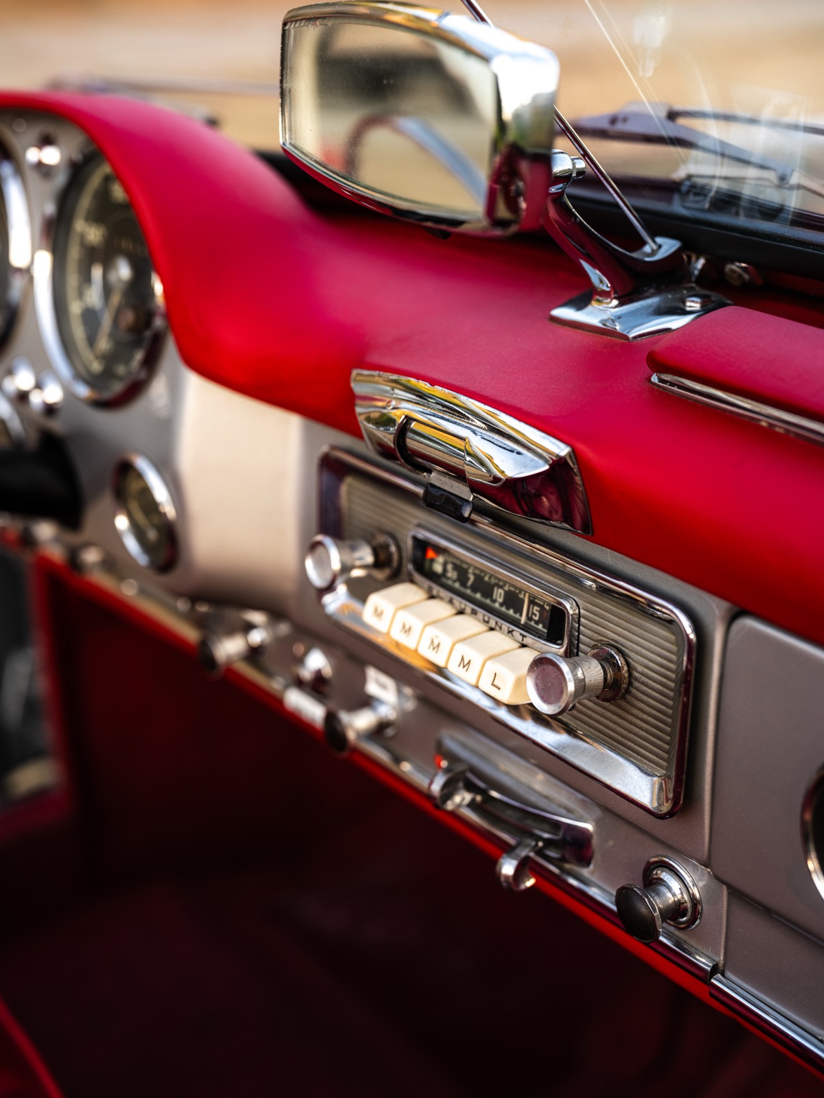 Original Becker radio and red leather dashboard detail in the Mercedes 190 SL