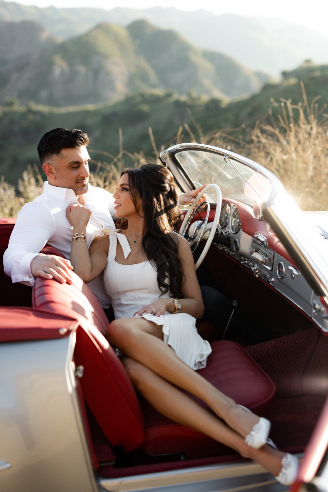 Engagement photoshoot in the red leather seats of the 190 SL in the Malibu canyons